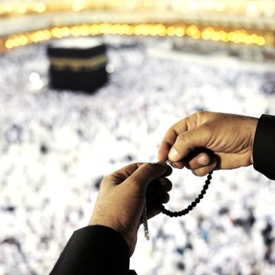 Muslim Arabic man praying at Kaaba in Mecca
